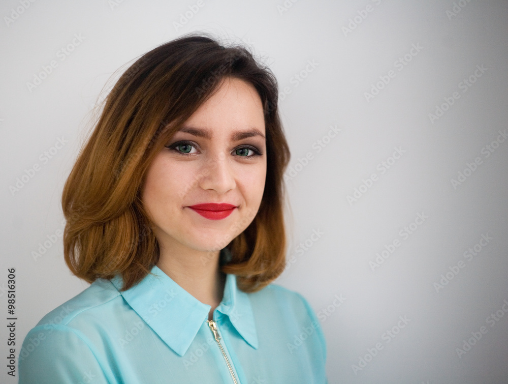 Girl smiling on gray background