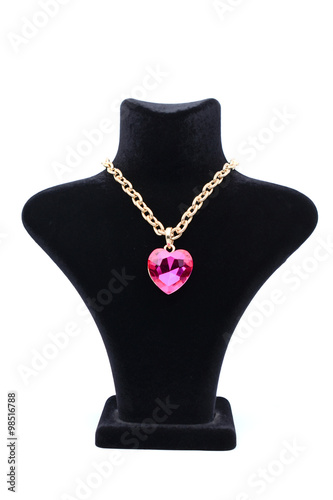 Pendant with pink heart on a mannequin isolated on white