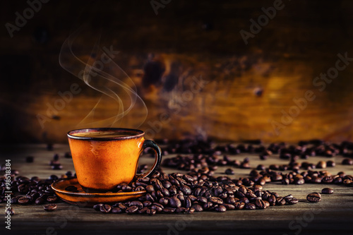 Coffee. Cup of black coffee and spilled coffee beans. Coffee break