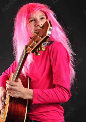  teenager with pink hair playing guitar