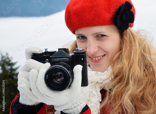 Woman with camera, outdoor photo