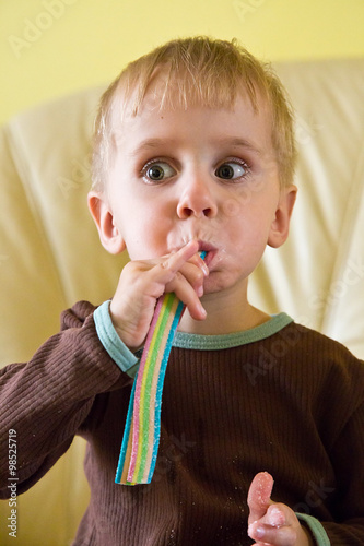 A boy eating soft jelly lollies photo