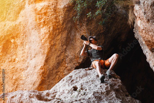 Male photographer on the cliff shooting on dslr camera