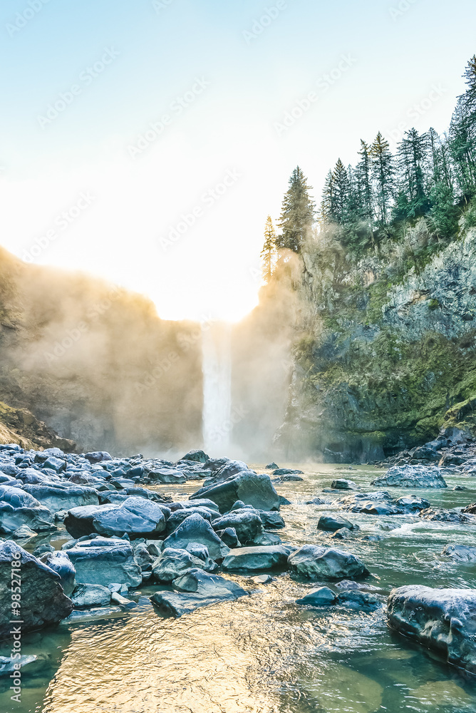 Fototapeta premium scenic view of Snoqualmie falls with golden fog when sunrise in winter season,Washington,USA.