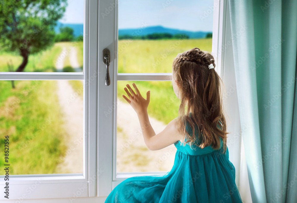 Sad girl looking through window Sad girl looking through window