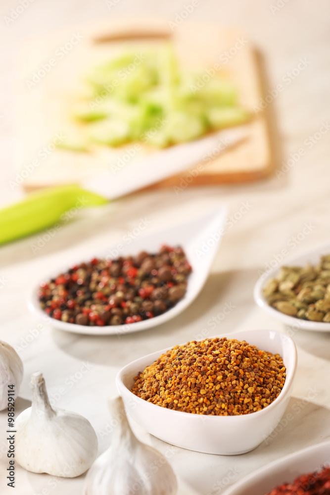 Variety of spices in ceramic containers on the kitchen table Variety of spices in ceramic containers on the kitchen table