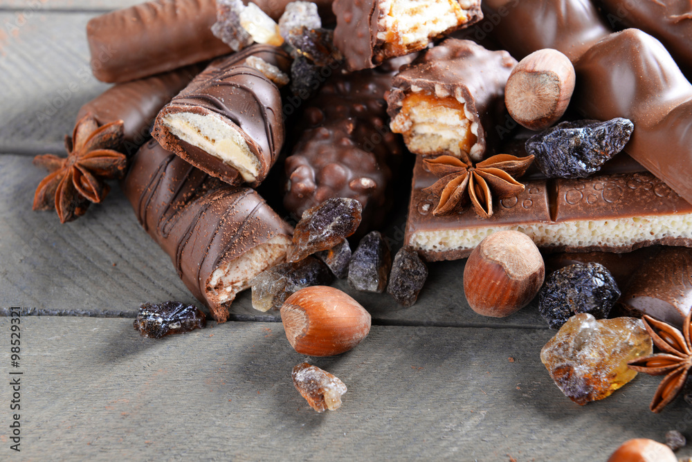Fototapeta premium Chocolate sweets with powder on wooden background