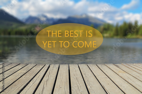 The best is yet to come text, mountain lake in the background photo