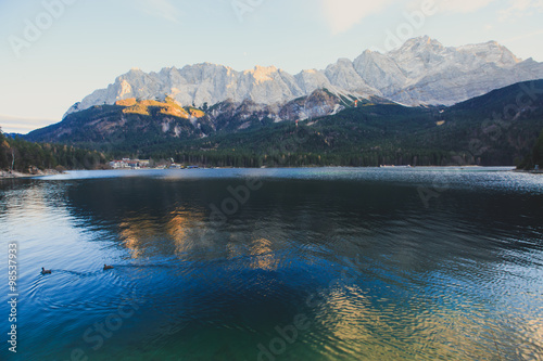Beautiful vibrant landscape with sundown on mountain lake Eibsee, located in the Bavaria, Germany, near Zugspitze mountain, Alps, Europe. 