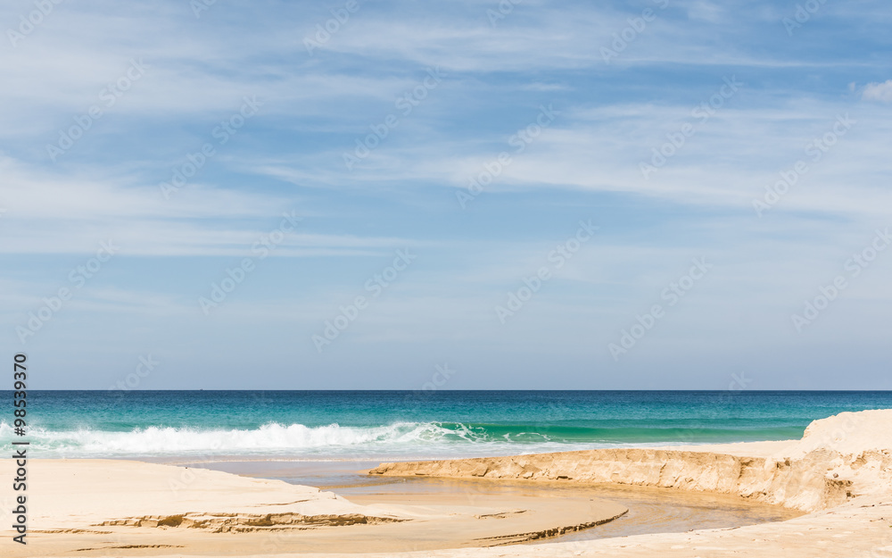 Beach, sea and cloudy blue sky