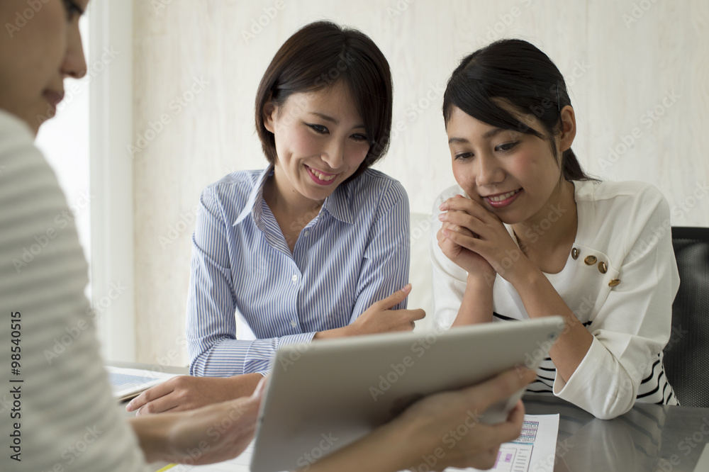 Women have a meeting with the electronic tablet Women have a meeting with the electronic tablet