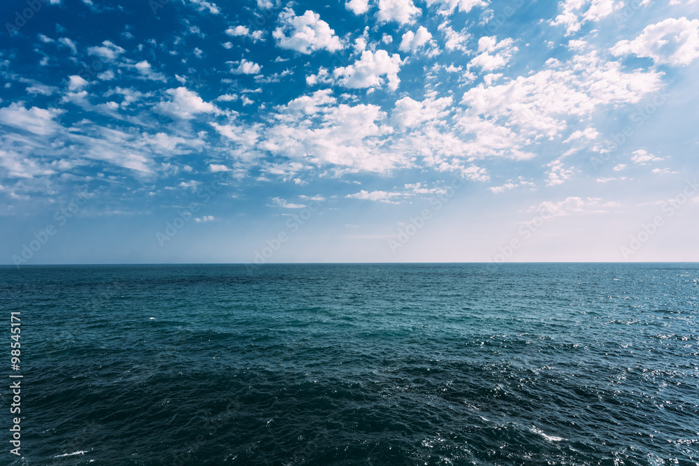 Fototapeta premium Cold Sea Ocean And Blue Sky Background With Cloudscape