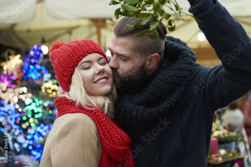 Kissing under the mistletoe is a tradition photo