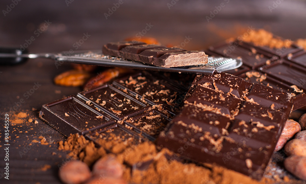 Chocolate products. Chocolate, cocoa beans, cocoa and nuts on wooden background. Chocolate products. Chocolate, cocoa beans, cocoa and nuts on wooden background.