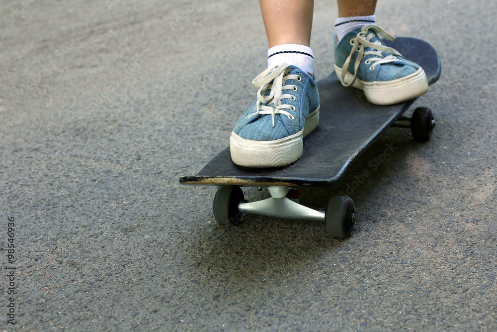 young girl riding on a skateboard closeup