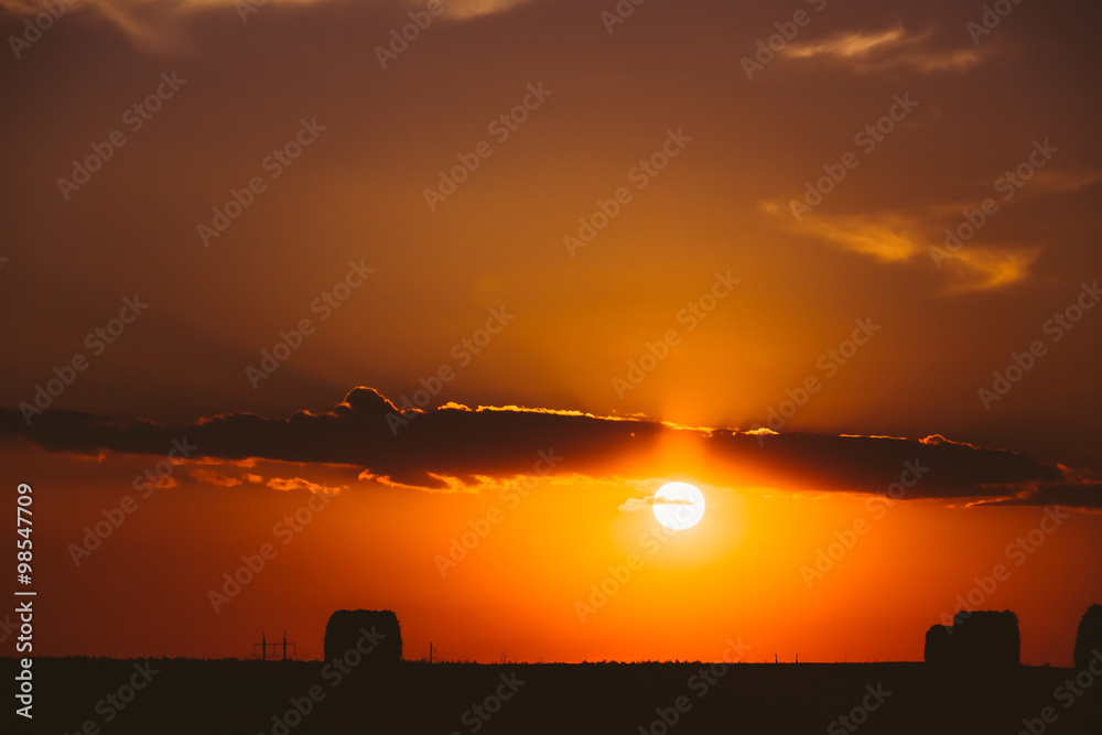 Naklejka premium Summer Field Meadow With Hay Bales Silhouettes, Sunset, Sunris