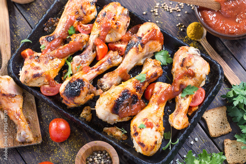 Hot and spicy chicken drumsticks on serving pan