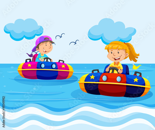 Boy and girl riding on rubber boats in ocean