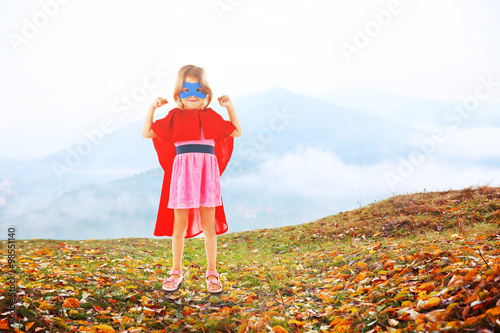 Superhero little girl on mo...