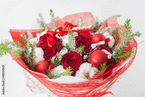 Fototapeta Naklejka Na Ścianę i Meble -  Close-up of Christmas winter bouquet of red rose and cotton in t