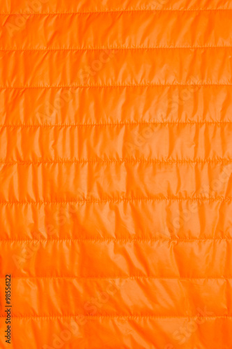 orange warm insulated texture of jacket,warm light weight insulation. photo