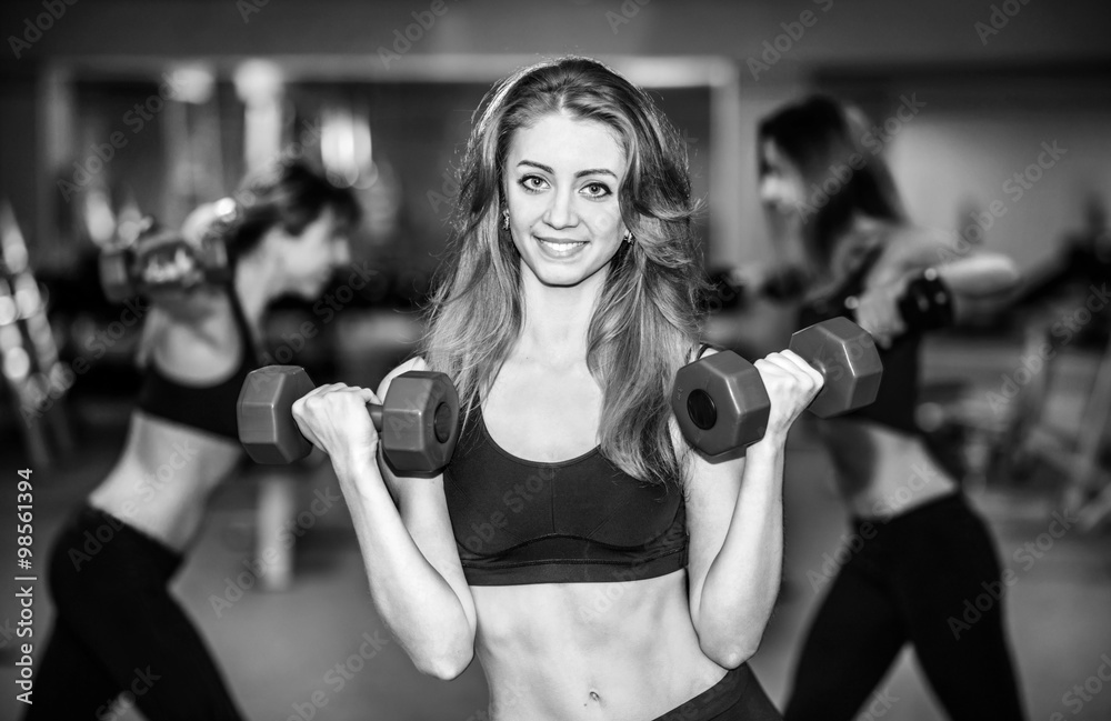 Three young girls workout in the gym Three young girls workout in the gym