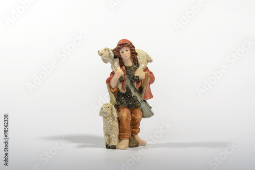 Shepherd with his sheep / Shepherd with his sheep, element of the Christmas nativity. White background with the Christmas decorations.