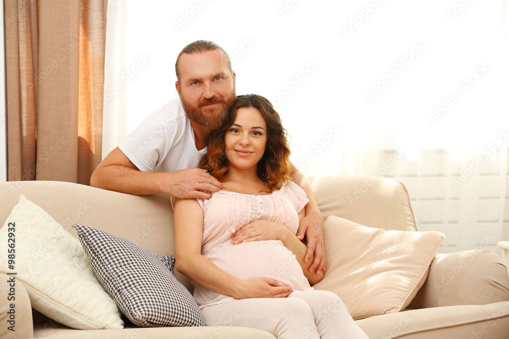 Handsome man takes care about his lovely pregnant woman Handsome man takes care about his lovely pregnant woman
