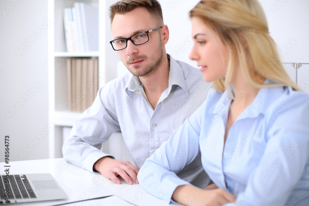 Two successful business partners working at meeting in office Two successful business partners working at meeting in office
