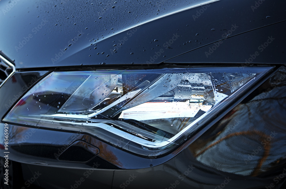 Obraz premium Car Headlights.Black vehicle front part close up of headlights and grille.