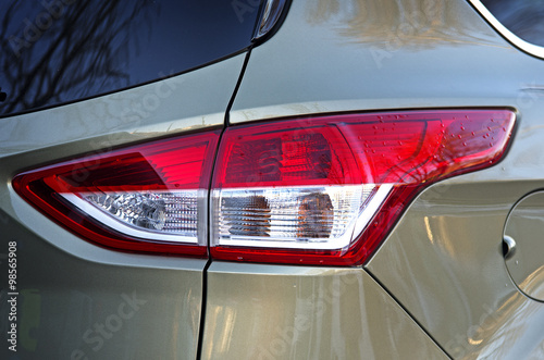  Car back lights. Metallic color vehicle rear part close up view from behind.