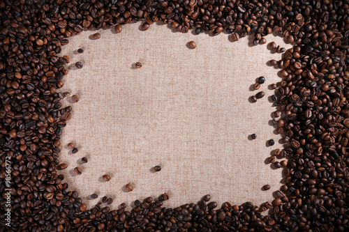 Frame of roasted coffee beans on the linen fabric