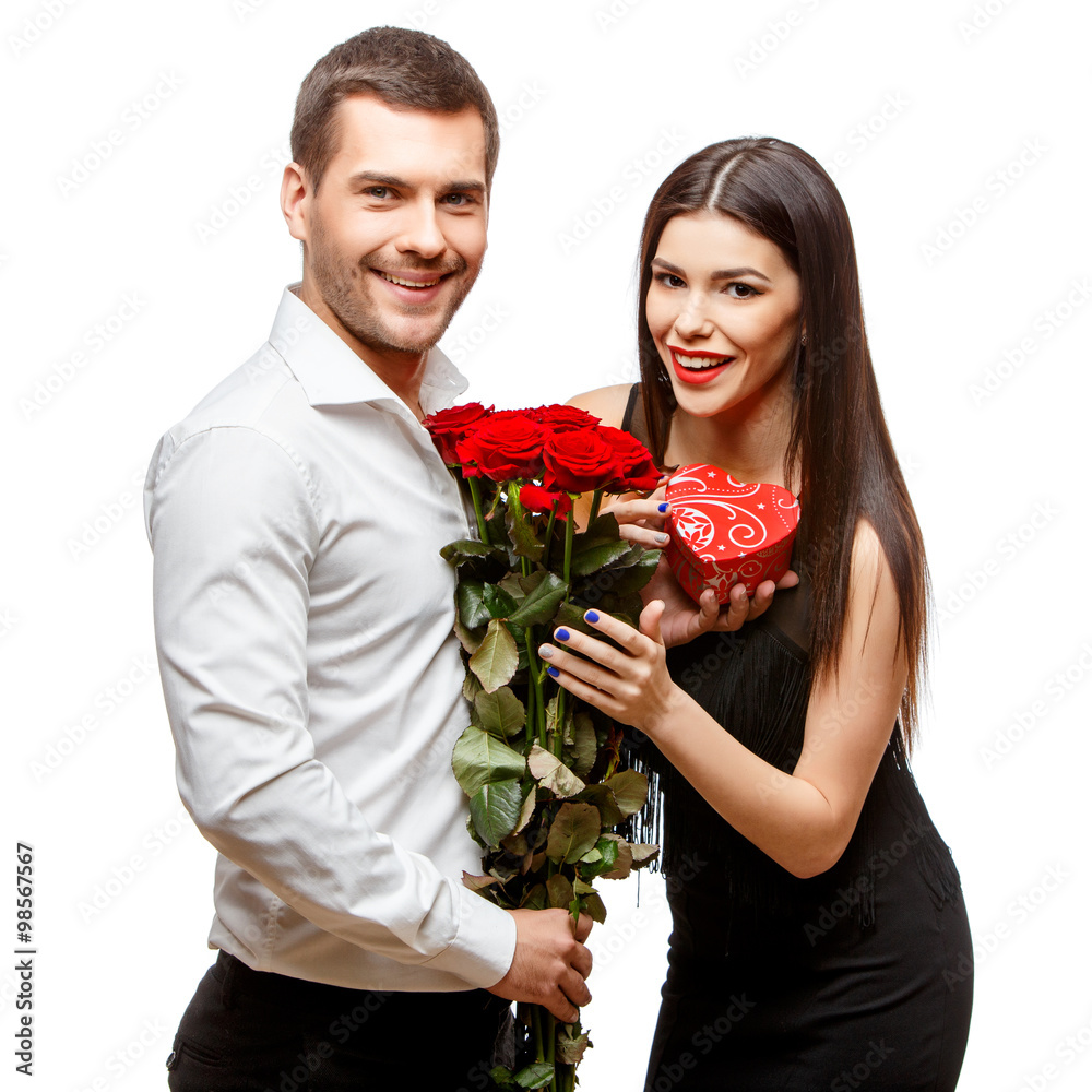 Young beautiful couple with present isolated on white