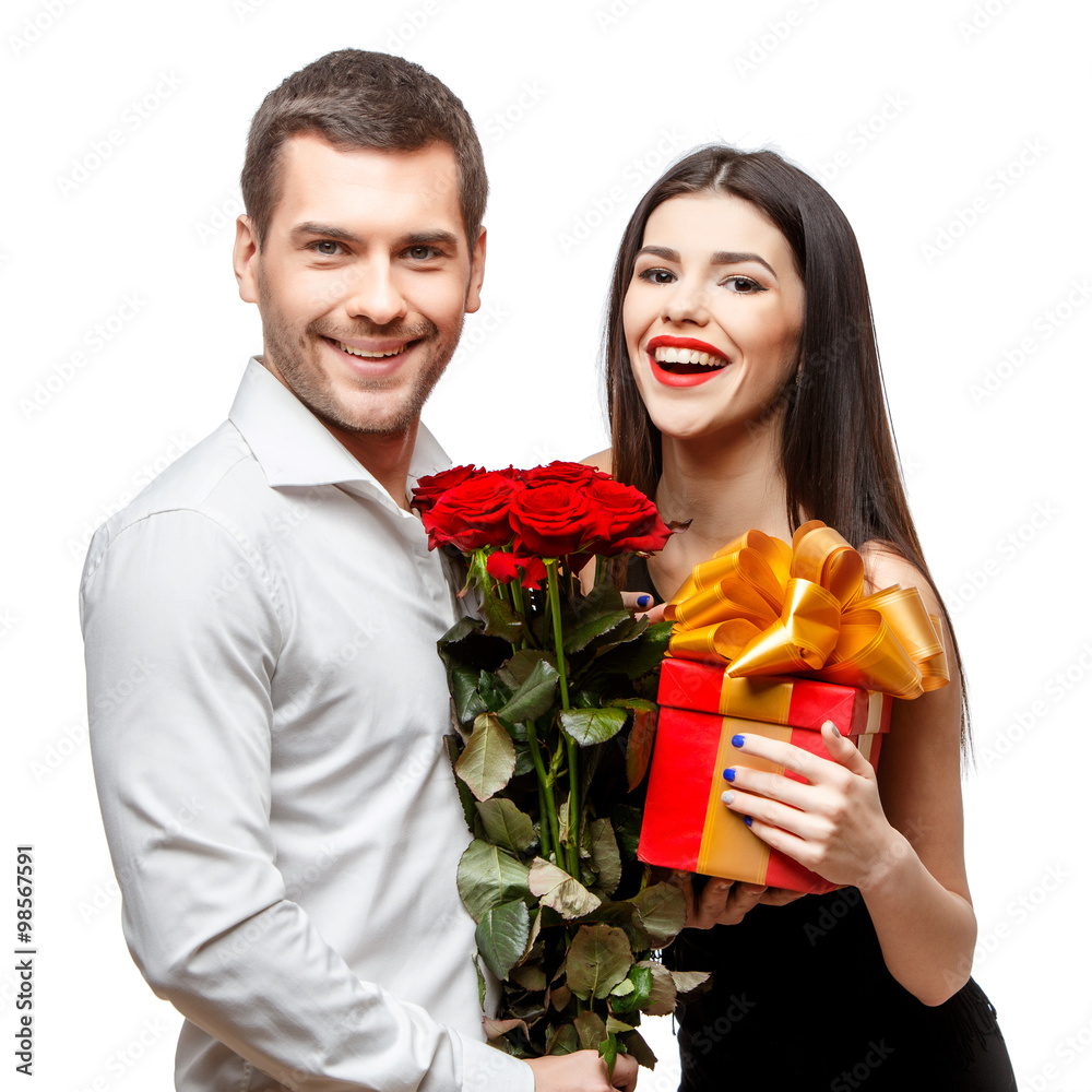 Young beautiful couple with present isolated on white Young beautiful couple with present isolated on white