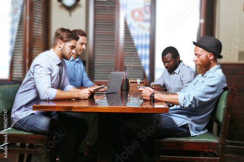 Young men talking in cafe