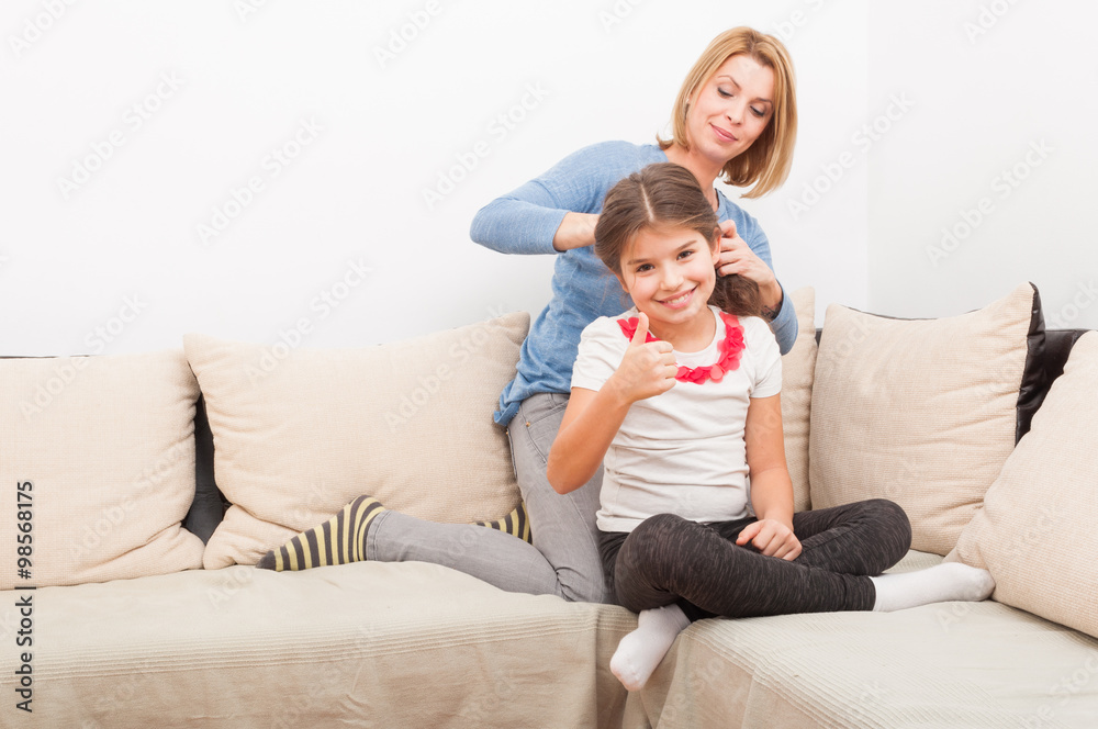 Happy young daughter and her mother at home