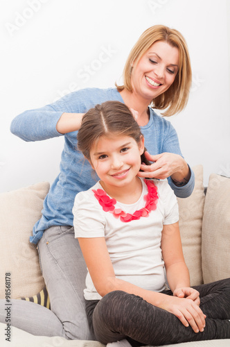 Happy and beautiful mother and daughter at home