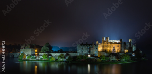 English castle with Christmas lights at night photo