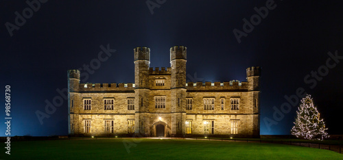English castle with Christmas lights at night