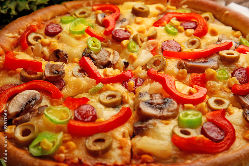 Delicious sliced pizza with vegetables, close-up Delicious sliced pizza with vegetables, close-up