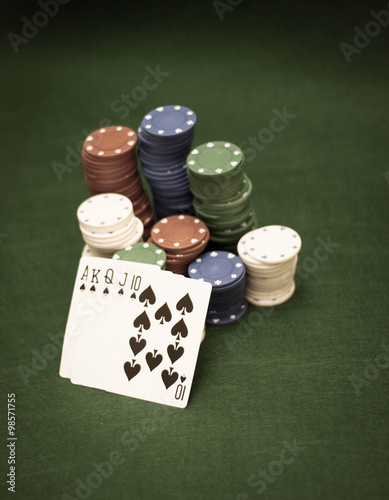 Cards and stack of poker chips and on a green background 