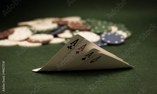 Cards and stack of poker chips and on a green background 
