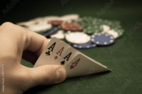 Cards and stack of poker chips and on a green background 