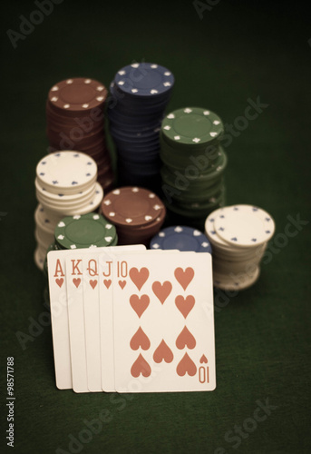 Cards and stack of poker chips and on a green background 
