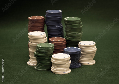 Stack of Poker chips on a green background