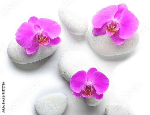 White spa stones and orchids isolated on white