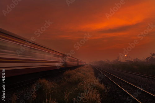 Train Passing by over Rural Railway in the Morning or at Dawn wi