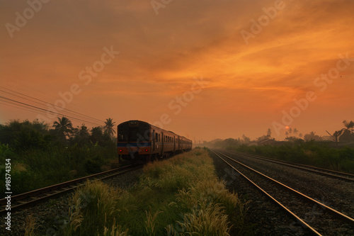 Train Passing by over Rural Railway in the Morning or at Dawn wi