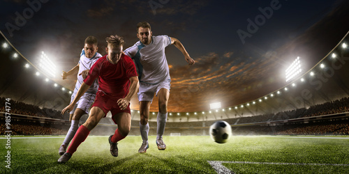 Soccer players in action on sunset stadium background panorama © 103tnn