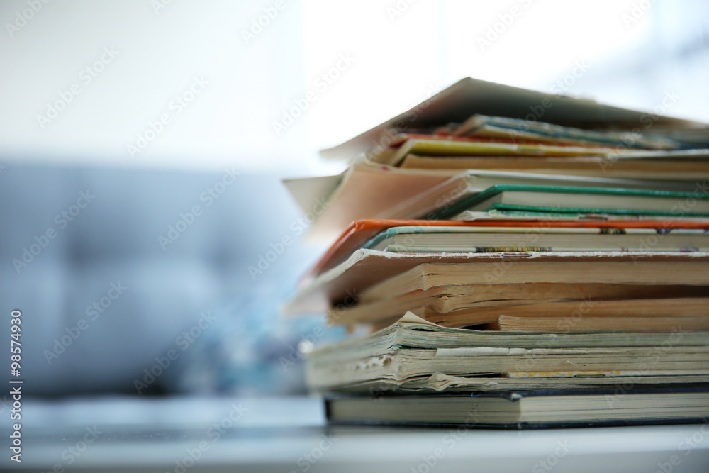 Pile of old books on white table Pile of old books on white table